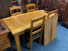 A modern heavy oak kitchen/dining table and four chairs - two extra leaves