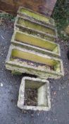 Four concrete garden planter troughs with pedestals and a planter