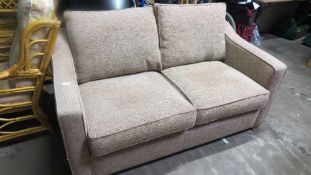 A fawn 2 seater sofa bed