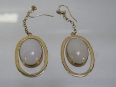 A pair of unmarked yellow metal earrings set with opal style stones