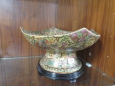 An Oriental style decorative table centre piece on stand
