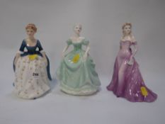 A Royal Doulton figurine with two Coalport examples