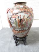 A large decorative Oriental style vase with dragon mask detail on stand
