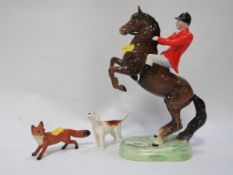 A Beswick rearing huntsman together a first version hound and a running fox - one ear missing