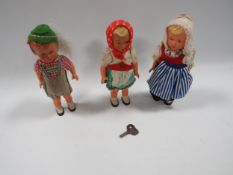 Three small vintage clockwork dolls (one winding key)