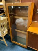 A teak glazed cabinet