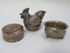 A Cambodian white metal betel nut box in the form of a rooster, together with a lidded box and a