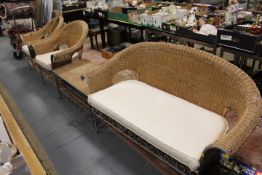 A four piece bent iron and wicker conservatory suite