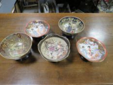 Five Oriental style bowls on stands