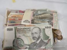 A box of world coins and banknotes