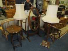 A vintage oak floor standing cheval mirror, together with two lamp standards and a barleytwist