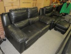 A two piece black leather suite, comprising a pair of two seater reclining sofas, together with a