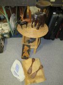 A tray of tribal treen together with a wicker work side table