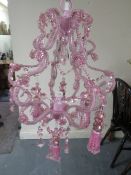 A small modern pink chandelier- ex shop stock, may have damage