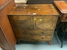 An antique mahogany commode cabinet
