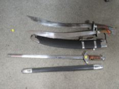 Two ceremonial style swords with sheaths, plus another
