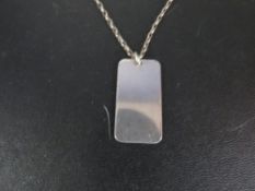 A silver dogtag on a silver chain