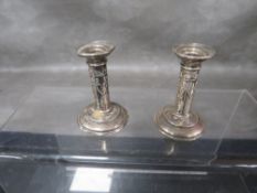 A pair of miniature hallmarked silver Edwardian style candlesticks