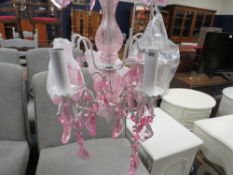 A small modern pink chandelier with box- ex shop stock, may have damage