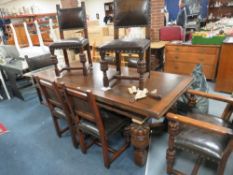 A Titchmarsh & Goodwin Jacobean style extending oak dining table and 8 chairs (six plus two