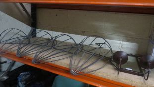 Four wrought iron wall hanging planters and a garden mirror