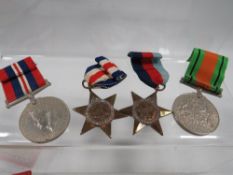 A set of four war medals in original Players Whiffs box