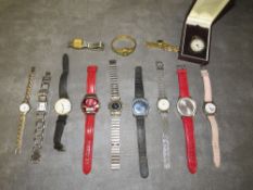 A tray of assorted wrist watches to include a silver fob watch