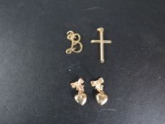 A cross pendant stamped 375 together with a hallmarked 9 carat gold initial pendant approx