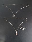 A silver necklace and earring set together with a silver necklace