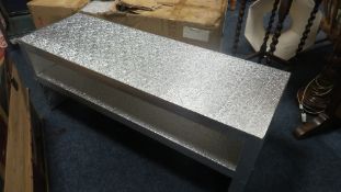 Two modern two tier tables in silver, with embossed finish, one boxed (Unchecked)