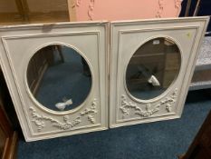 A pair of modern white wall mirrors