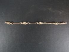 An unmarked yellow metal hand-made bracelet with unusual ball in cage design length 18.5cm approx
