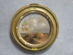 A 19th century French school oil on board circular wooded landscape