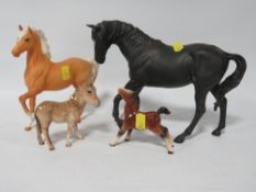 A Beswick Black Beauty figurine together with a palomino horse and Beswick donkey and another (4)