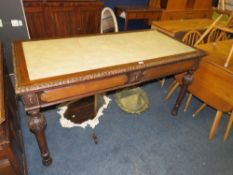 A leather topped two drawer oak library table, with carved border and carved / fluted legs. W 153