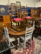 An oak dining table with two extra leaves together with six chairs (four painted)