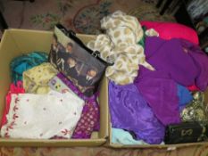Two trays of assorted Asian clothing to include scarfs etc