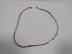 A hallmarked 9 carat three coloured gold herringbone necklace approx weight 5.5g