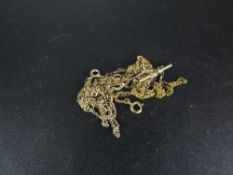 A quantity of yellow metal chains - tangled