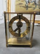A Kundo electronic pendulum coil operated mantle clock