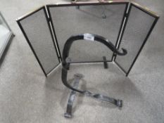 A bent wrought iron stand together with a fireguard
