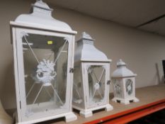 Three graduated hurricane lanterns
