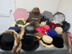 A large quantity of assorted vintage hats, hat boxes, fur stoles and parasols etc to include many