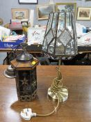 A modern light fitting together with a modern table lamp and shade