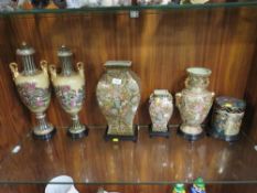 Six Oriental style vases on stands