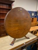 An antique mahogany reduced tilt top table