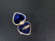 A hallmarked 18 carat gold diamond ring - two stones missing approx weight 2.2g