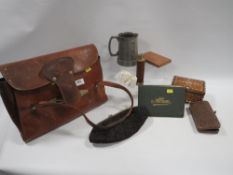 A leather satchel containing assorted vintage collectables