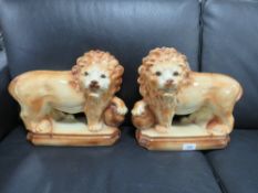 A pair of vintage ceramic lion figures