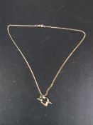A hallmarked 9 carat gold chain together with a hallmarked 9 carat gold heart and arrow pendant
